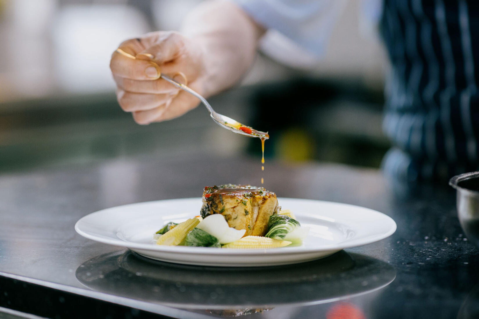 An image of one of the fine dining meals being prepared