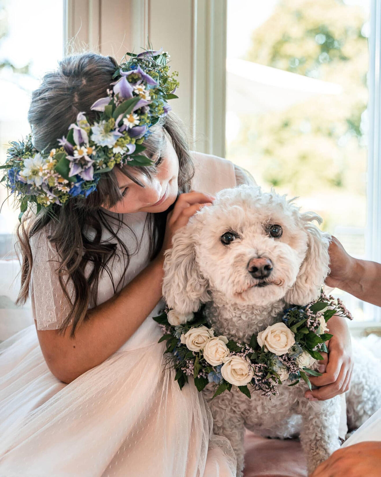 An image of a flower girl and a dog