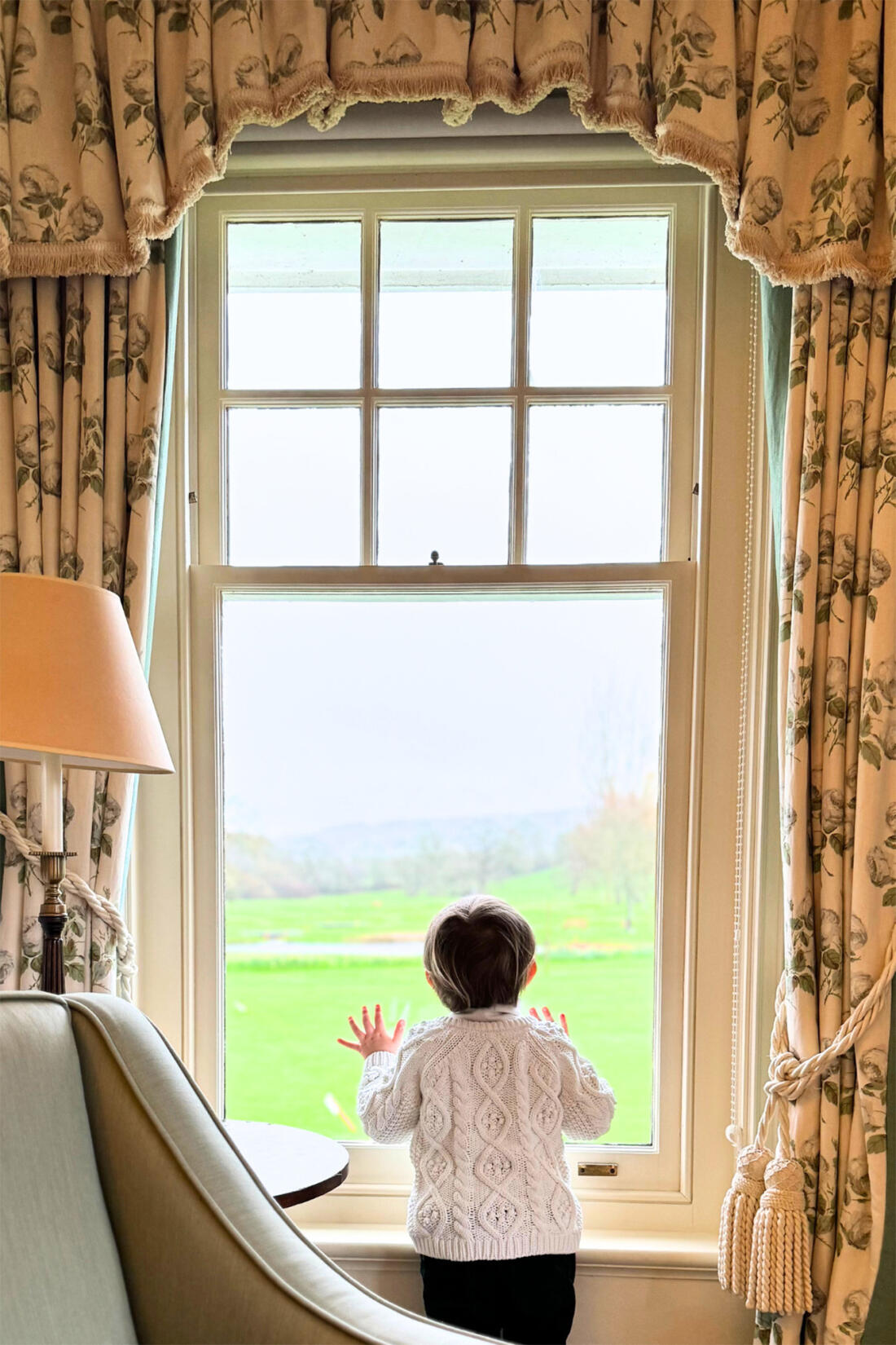 A image of a young boy looking out the window
